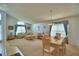 Spacious living room and dining area with neutral carpet, ample natural light, and stylish furnishings at 2721 Kokomo Loop, Haines City, FL 33844