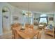 Bright and open-concept living room and dining area with vaulted ceiling, tile entry, and comfortable seating at 2721 Kokomo Loop, Haines City, FL 33844