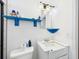 Cozy bathroom with custom blue shelving, classic white vanity and neutral wall color at 2726 Prine Rd, Lakeland, FL 33810