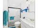 Modern bathroom featuring glass shower, white tile, and blue accents at 2726 Prine Rd, Lakeland, FL 33810