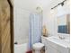 Bathroom with tile shower, bathtub, and decorative shower curtain at 2726 Prine Rd, Lakeland, FL 33810