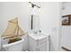 Bathroom with white vanity, mirror, and a decorative ship model at 2726 Prine Rd, Lakeland, FL 33810