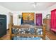 Bedroom featuring a rustic bed frame, safe, and a decorative headboard at 2726 Prine Rd, Lakeland, FL 33810