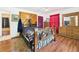 Bedroom showing wood floors, headboard with wood accents, and dresser at 2726 Prine Rd, Lakeland, FL 33810