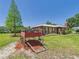 A red wagon accentuates the exterior of this brick home with a well-manicured lawn at 2726 Prine Rd, Lakeland, FL 33810