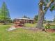 Charming brick home with mature landscaping and a decorative wagon accent at 2726 Prine Rd, Lakeland, FL 33810