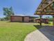 Brick outbuilding next to garage with boat parking and green lawn at 2726 Prine Rd, Lakeland, FL 33810