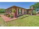 Exterior view of brick home showcasing the landscaping and outdoor pathway at 2726 Prine Rd, Lakeland, FL 33810