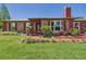 Charming brick home with well-maintained landscaping, including a cozy porch, green lawn, and sidewalk at 2726 Prine Rd, Lakeland, FL 33810
