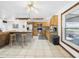 Updated kitchen featuring stainless steel appliances, a bar-top kitchen island, and tile floors at 2726 Prine Rd, Lakeland, FL 33810