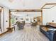 Expansive living space with wood beams, plentiful seating, and views into the large eat-in kitchen at 2726 Prine Rd, Lakeland, FL 33810