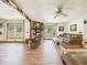 Bright living room featuring wood floors, natural light, stone fireplace, and comfortable couches at 2726 Prine Rd, Lakeland, FL 33810