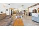 Open concept living room featuring wood floors, kitchen access, and plenty of natural light at 2726 Prine Rd, Lakeland, FL 33810