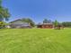 Expansive green lawn with outbuildings and barn, ideal for outdoor activities at 2726 Prine Rd, Lakeland, FL 33810
