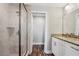 Bathroom showcasing a glass shower, granite countertop, and white cabinetry at 310 N 1St Ave, Bartow, FL 33830