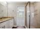 Bathroom with granite countertop, walk-in shower, and a view into bedroom at 310 N 1St Ave, Bartow, FL 33830