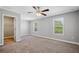 Spacious bedroom with carpet flooring, a ceiling fan, and a walk-in closet at 310 N 1St Ave, Bartow, FL 33830