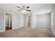 Bright, carpeted bedroom featuring a ceiling fan, closet, and neutral color scheme at 310 N 1St Ave, Bartow, FL 33830
