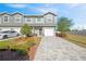 Charming townhome with gray siding, well-maintained landscaping, and a paved driveway leading to a one-car garage at 310 N 1St Ave, Bartow, FL 33830