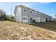 The exterior of this home features a fenced backyard with a small concrete patio at 310 N 1St Ave, Bartow, FL 33830