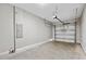 Spacious garage area featuring a garage door, an electrical panel, and concrete flooring at 310 N 1St Ave, Bartow, FL 33830