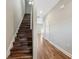 Hallway with hardwood flooring, staircase, white doors, neutral paint, and recessed lighting at 310 N 1St Ave, Bartow, FL 33830
