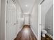 Hallway with hardwood flooring, white doors, neutral paint, and recessed lighting at 310 N 1St Ave, Bartow, FL 33830