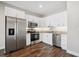 Modern kitchen featuring stainless steel appliances, granite countertops, and white cabinetry at 310 N 1St Ave, Bartow, FL 33830