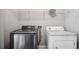 Convenient laundry area featuring a newer washing machine, dryer hookups, and shelving for storage solutions at 310 N 1St Ave, Bartow, FL 33830