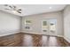 Bright living room featuring hardwood floors, ceiling fan, large window, and sliding glass doors at 310 N 1St Ave, Bartow, FL 33830