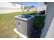 Close-up of air conditioner in backyard, with a partial view of outdoor furniture and backyard space at 3440 Dahlia Dr, Haines City, FL 33844