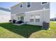 Image shows a backyard with a patio set, grill, and air conditioning unit at 3440 Dahlia Dr, Haines City, FL 33844