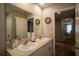 Bathroom featuring double sinks, a large mirror, and a neutral color scheme, offering convenience and style at 3440 Dahlia Dr, Haines City, FL 33844