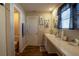 Well-lit bathroom featuring a vanity with ample counter space, a mirror, and a separate toilet area for privacy at 3440 Dahlia Dr, Haines City, FL 33844
