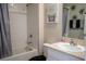 Bathroom featuring a tub/shower combination, a vanity with a sink, and a decorative mirror at 3440 Dahlia Dr, Haines City, FL 33844