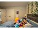 Bright bedroom featuring playful decor, plush toys, and a comfortable bed, creating a cozy atmosphere at 3440 Dahlia Dr, Haines City, FL 33844