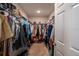 Organized walk-in closet with shelving and hanging space, perfect for maximizing storage and keeping items tidy at 3440 Dahlia Dr, Haines City, FL 33844