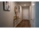 Hallway with hardwood floors and decorative artwork on the walls at 3440 Dahlia Dr, Haines City, FL 33844
