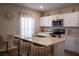 A kitchen featuring an island with bar stools and modern stainless steel appliances at 3440 Dahlia Dr, Haines City, FL 33844