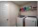 Functional laundry room with modern washer and dryer, ample storage space, and a clean aesthetic at 3440 Dahlia Dr, Haines City, FL 33844