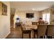 Open-concept living area with hardwood floors and a large TV, perfect for entertaining and relaxation at 3440 Dahlia Dr, Haines City, FL 33844