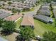 Aerial view of a well-planned community with manicured lawns and houses with brown roofs at 3565 Raleigh Dr, Winter Haven, FL 33884
