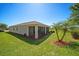 The backyard features a manicured lawn, mature trees, and a screened lanai at 3565 Raleigh Dr, Winter Haven, FL 33884