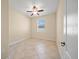 Simple bedroom with tile flooring, ceiling fan, and a window for natural light at 3565 Raleigh Dr, Winter Haven, FL 33884