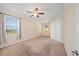 Spacious bedroom features a ceiling fan, large windows, and neutral carpeting at 3565 Raleigh Dr, Winter Haven, FL 33884