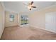 Bedroom with neutral carpeting, ceiling fan, and sliding glass doors to the lanai at 3565 Raleigh Dr, Winter Haven, FL 33884