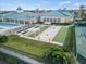 An aerial shot showcases the community clubhouse, pool, tennis courts, and shuffleboard courts, creating a vibrant recreation area at 3565 Raleigh Dr, Winter Haven, FL 33884