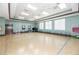 Spacious community room with large windows, ceiling fans, seating, and exercise equipment, offering a flexible space for residents at 3565 Raleigh Dr, Winter Haven, FL 33884