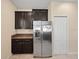 The kitchen area boasts stainless steel refrigerator, granite counters, and dark wood cabinets at 3565 Raleigh Dr, Winter Haven, FL 33884