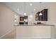 An open kitchen features granite countertops, stainless steel appliances, and dark wood cabinetry at 3565 Raleigh Dr, Winter Haven, FL 33884